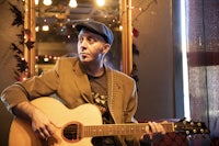 a man playing an acoustic guitar